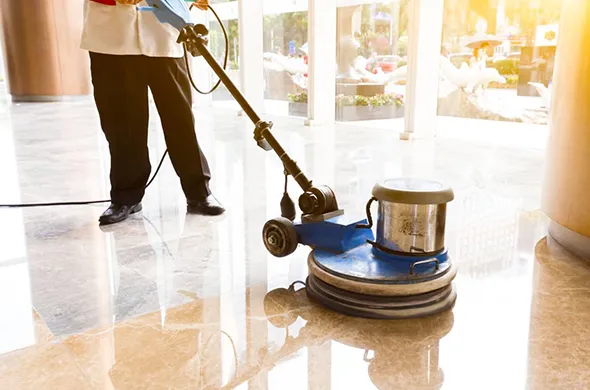 Close-up of efficient tile floor refinishing and restoration in Lakeline OH, featuring a worker polishing a sleek, restored tile surface.