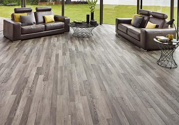 Modern living room with residential vinyl floor installation in Willoughby OH, featuring a cozy couch and stylish vinyl flooring.